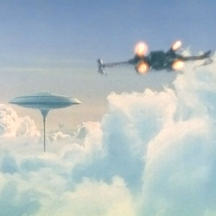 an alien ship flying through the sky above clouds