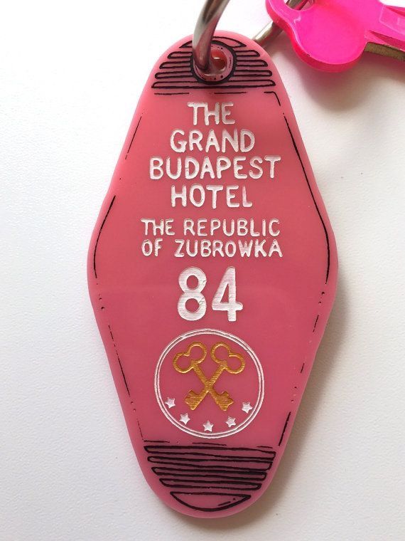 a keychain with the name and number on it that says the grand budapest hotel