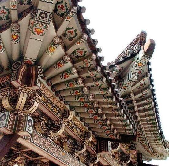 an elaborately decorated building stands in front of trees