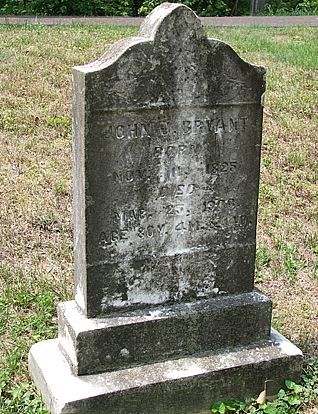 the headstone of an old man and woman in a cemetery with trees in the background