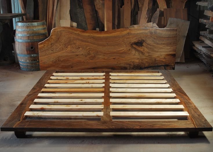 a bed frame made out of wood in a room