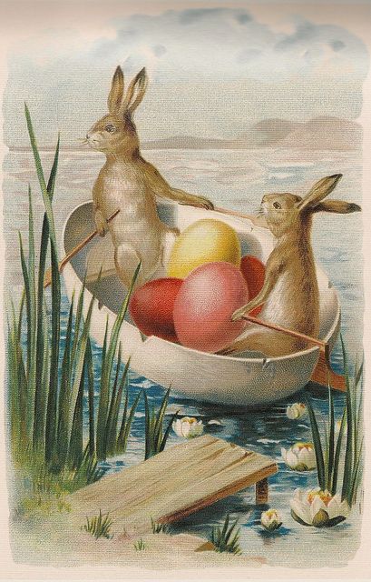 an easter card with two rabbits in a row boat filled with eggs and water lilies