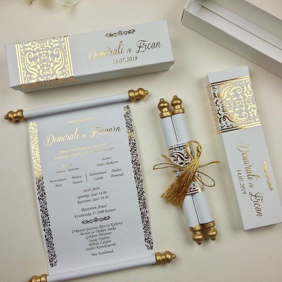 the wedding stationery is laid out on top of each other, including an envelope and pen