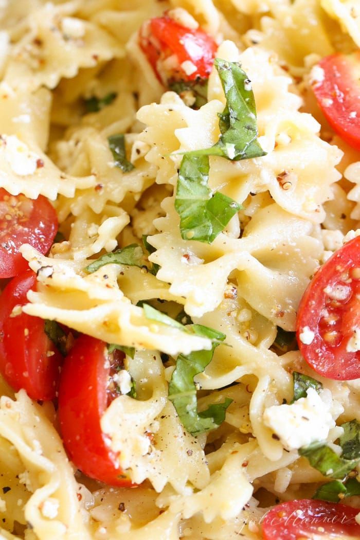 pasta salad with tomatoes, spinach and parmesan cheese