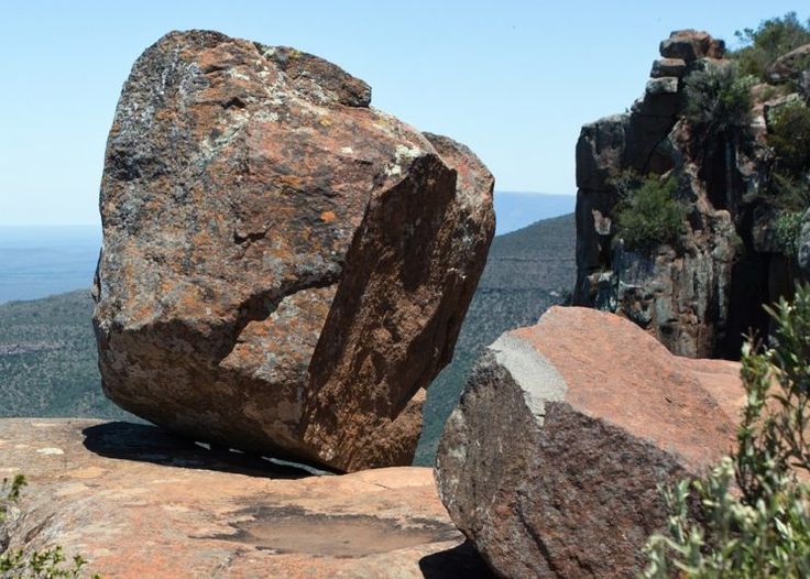 two large rocks sitting on top of a mountain