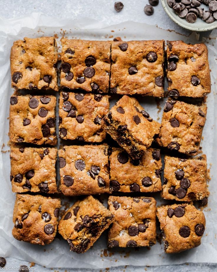 chocolate chip cookie bars cut into squares on top of parchment paper