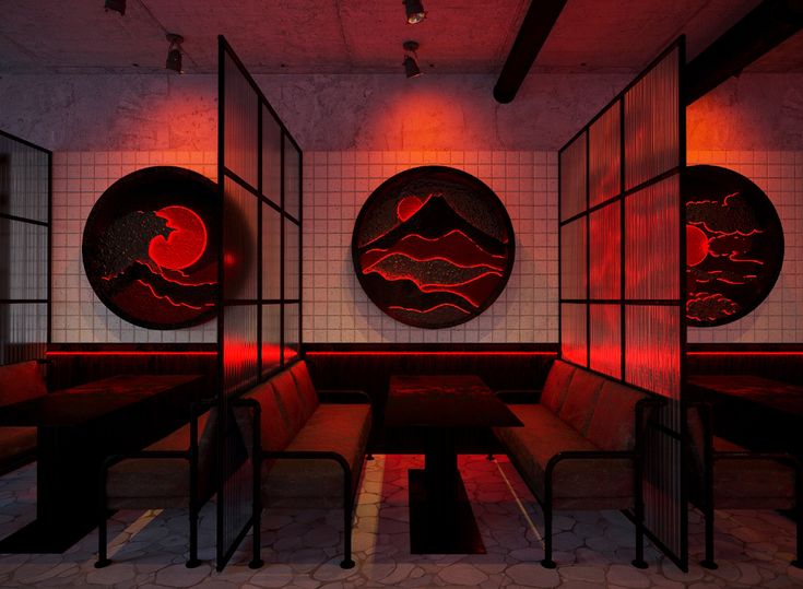 an empty restaurant with red lights on the ceiling and round artwork hanging from the walls