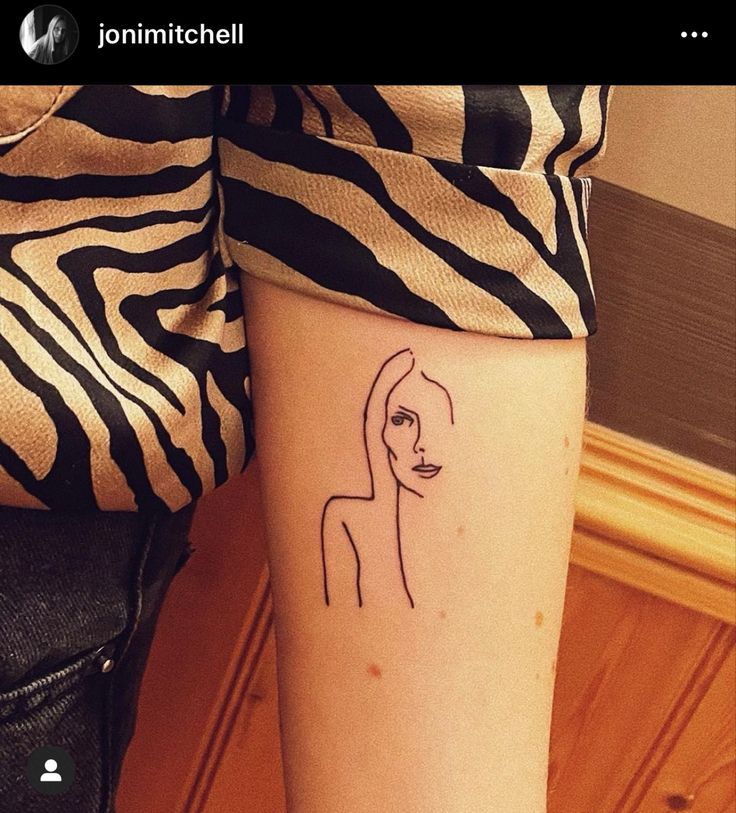 a woman's arm with a line drawing of a woman on the left side