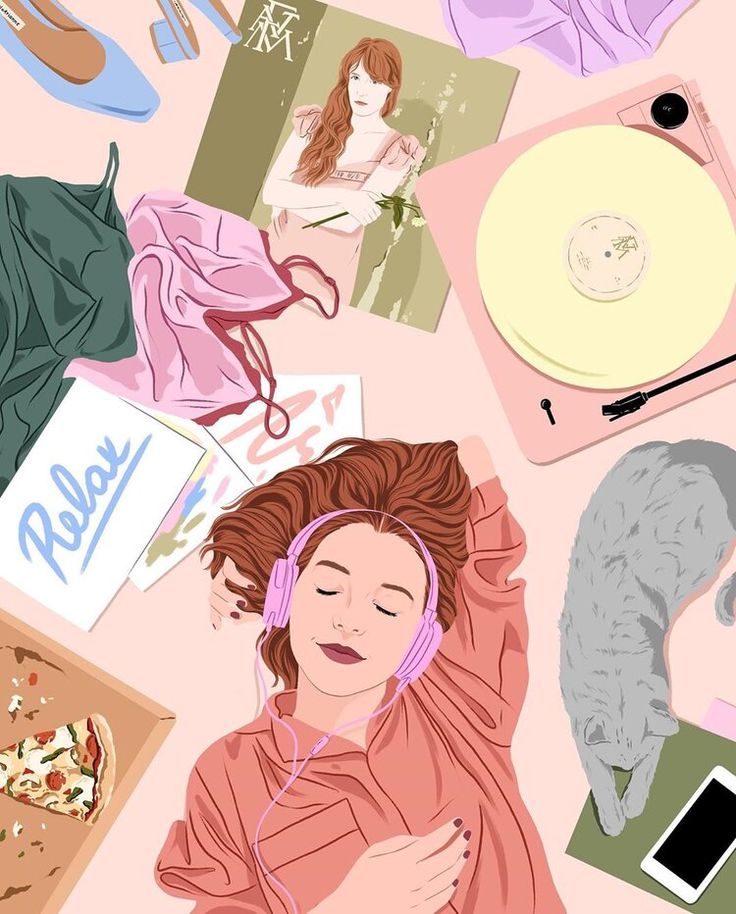 a woman laying on top of a bed with headphones and various items around her