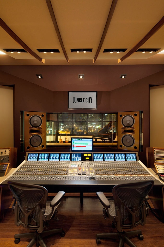 an empty recording studio with many sound equipment