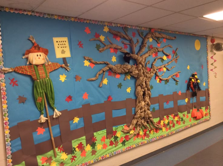 a bulletin board with scarecrows on it and a tree in the center,