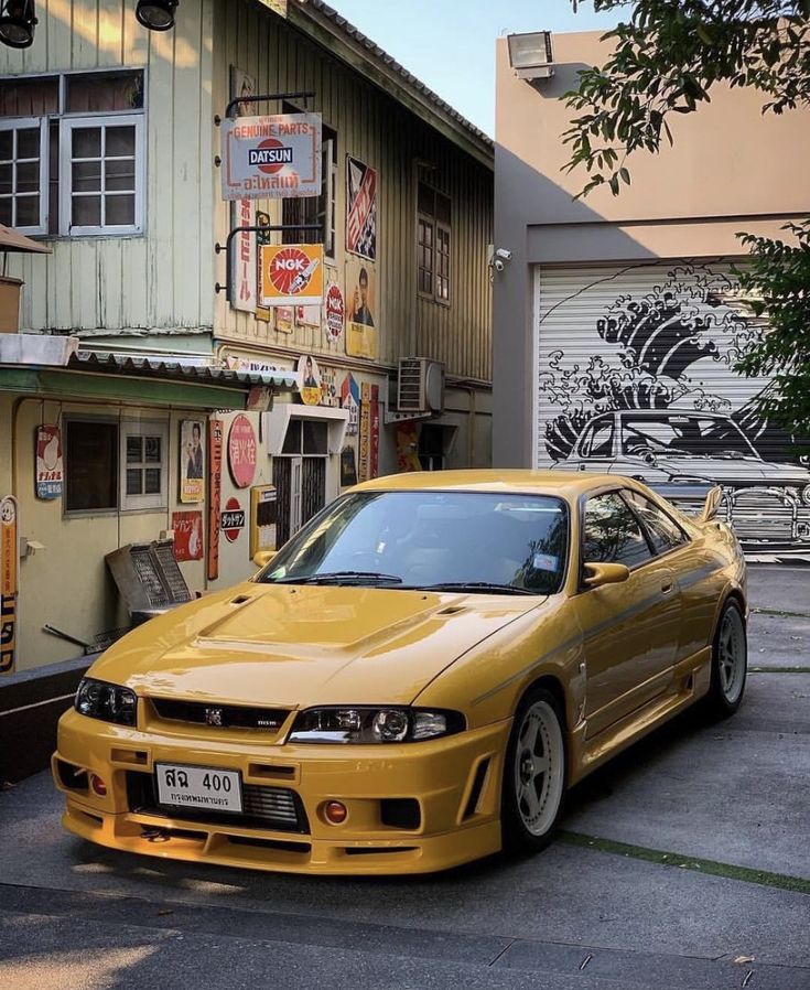 a yellow car parked in front of a building