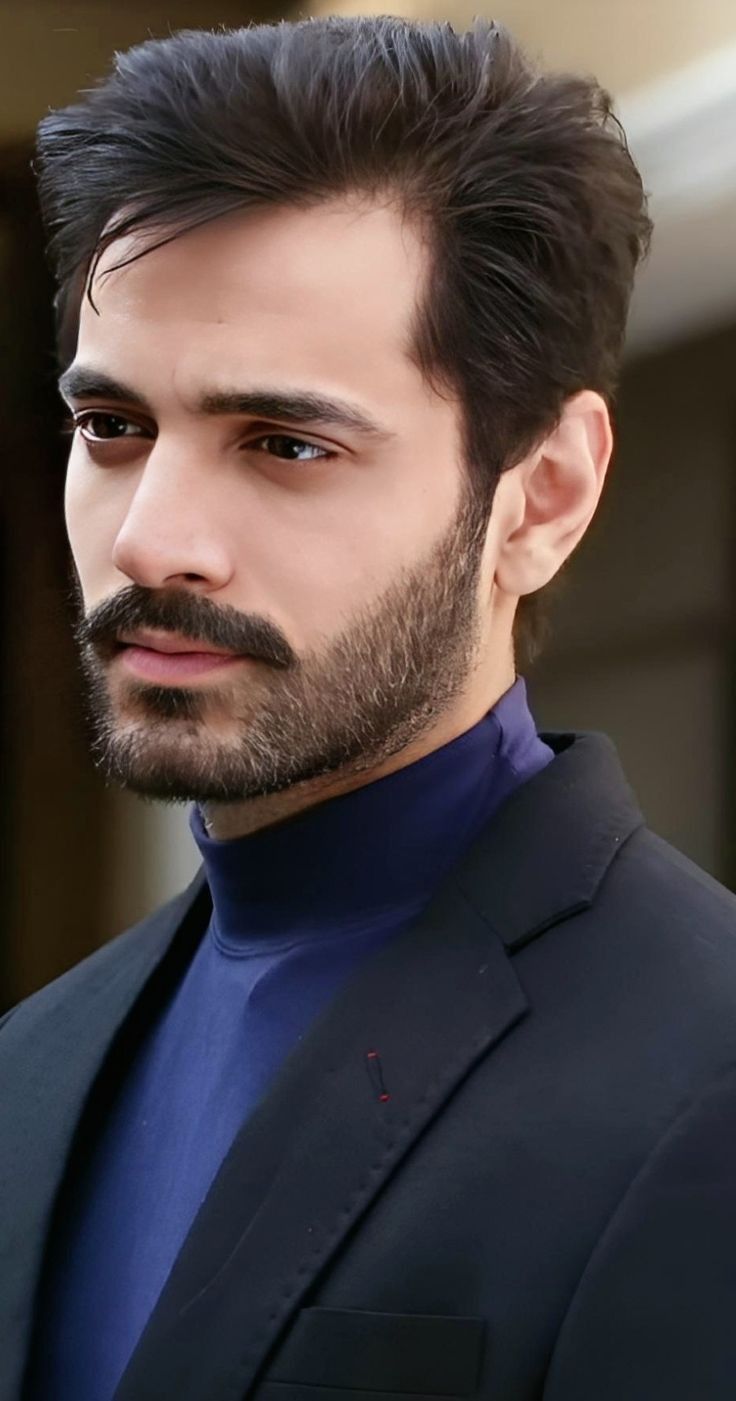 a close up of a person wearing a suit and tie with a serious look on his face