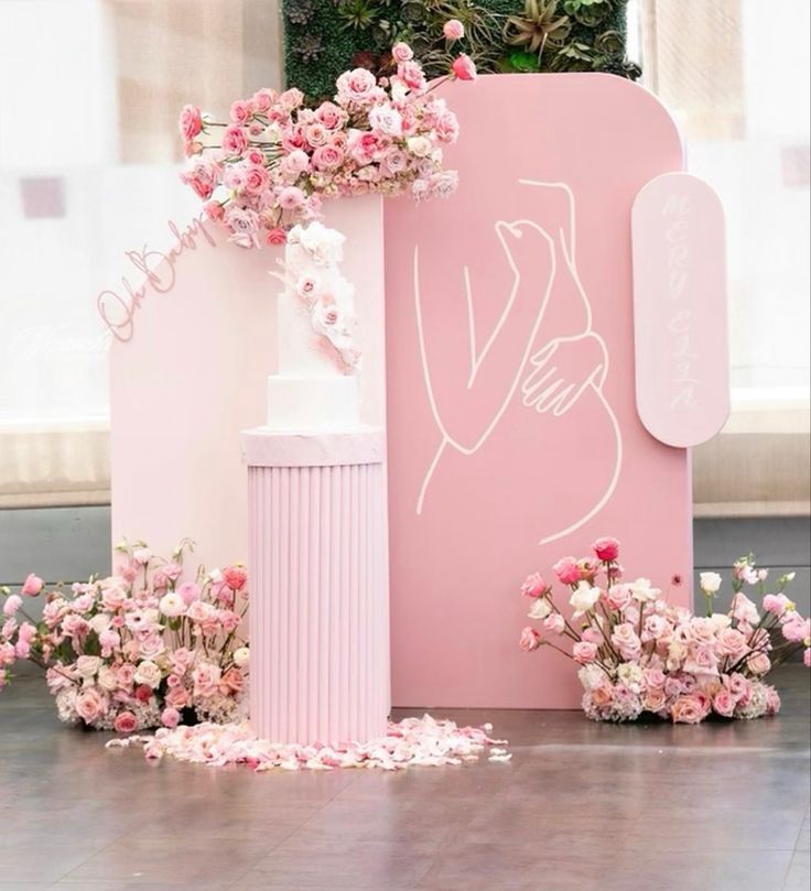 a pink box with flowers on the floor next to it