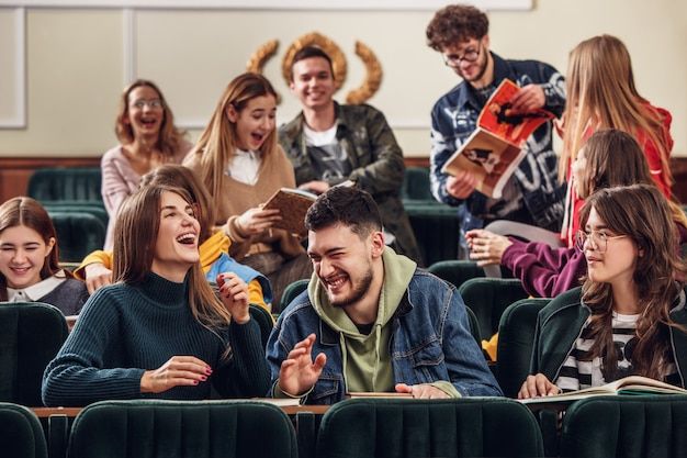 a group of people sitting in front of a classroom full of them laughing and having fun