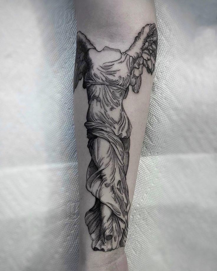 an angel tattoo on the leg