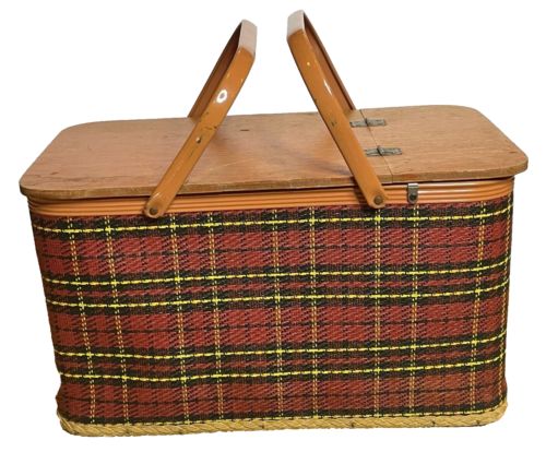 a brown and yellow plaid picnic basket with two wooden handles on the front, sitting against a white background