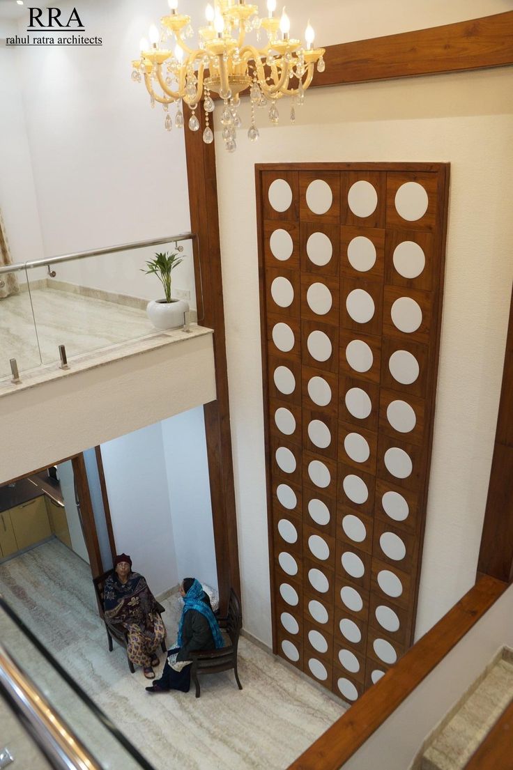 two people are sitting on the stairs in a building