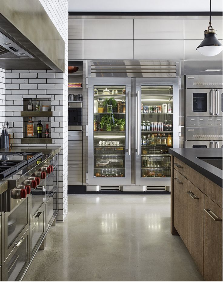 a kitchen with stainless steel appliances and an advertisement for the new appliance company wow