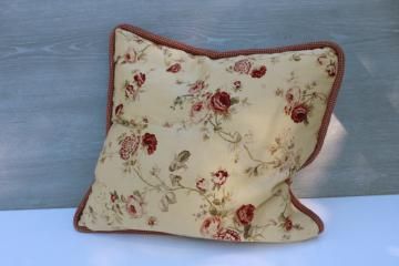 a pillow that is on top of a white table next to a blue wall and wooden planks