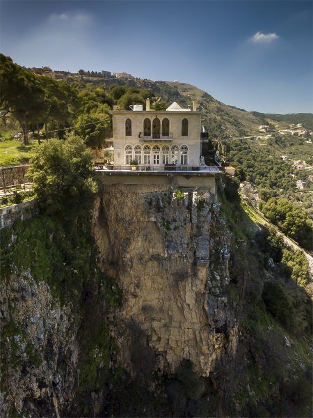 a large house on top of a cliff