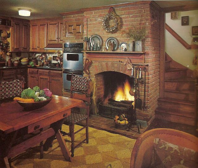 an image of a kitchen with a fireplace in the center and pictures on the wall