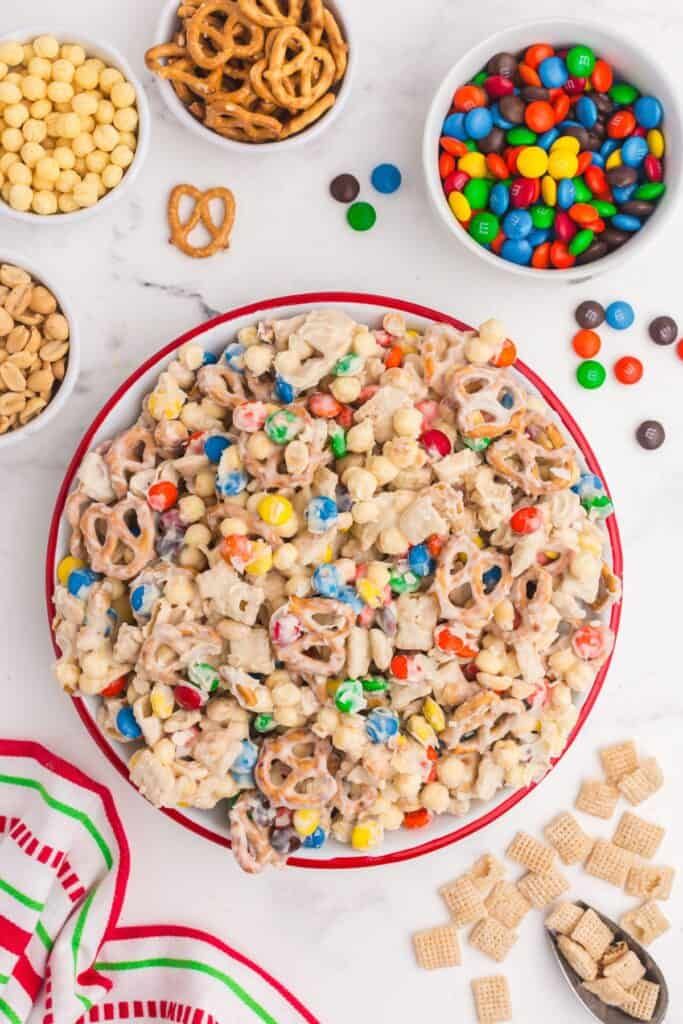 a bowl filled with cereal, pretzels and candy