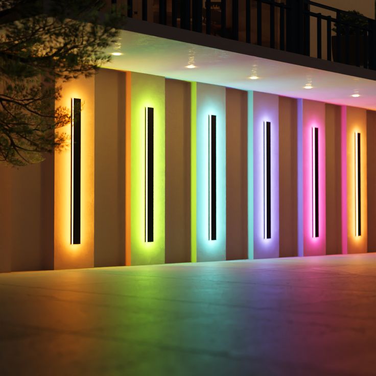 the lights are brightly lit up in front of a building's wall and floor