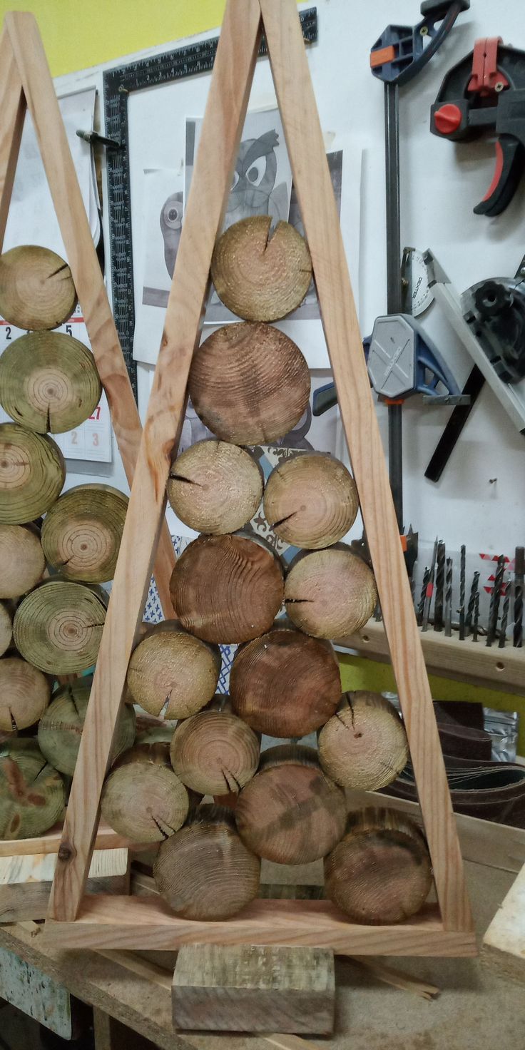 two wooden logs stacked on top of each other in front of a workbench