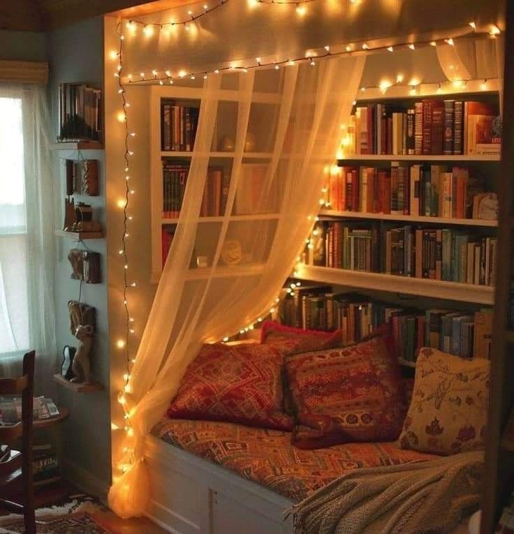 a bed with bookshelves and lights on it