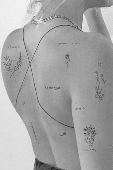 the back of a woman's body with tattoos on it