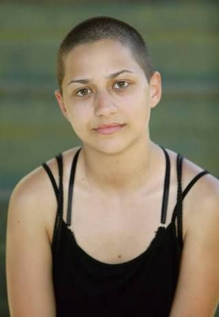 a woman in black tank top sitting down