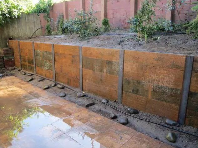 there is a wooden fence that has been built into the ground