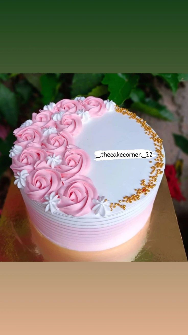 a white and pink cake with flowers on it