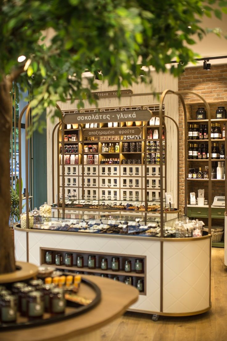 the inside of a store with many items on display and trees in the foreground