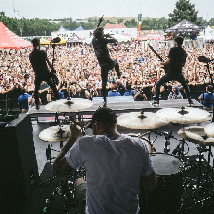 a group of people that are on stage with musical instruments in front of an audience