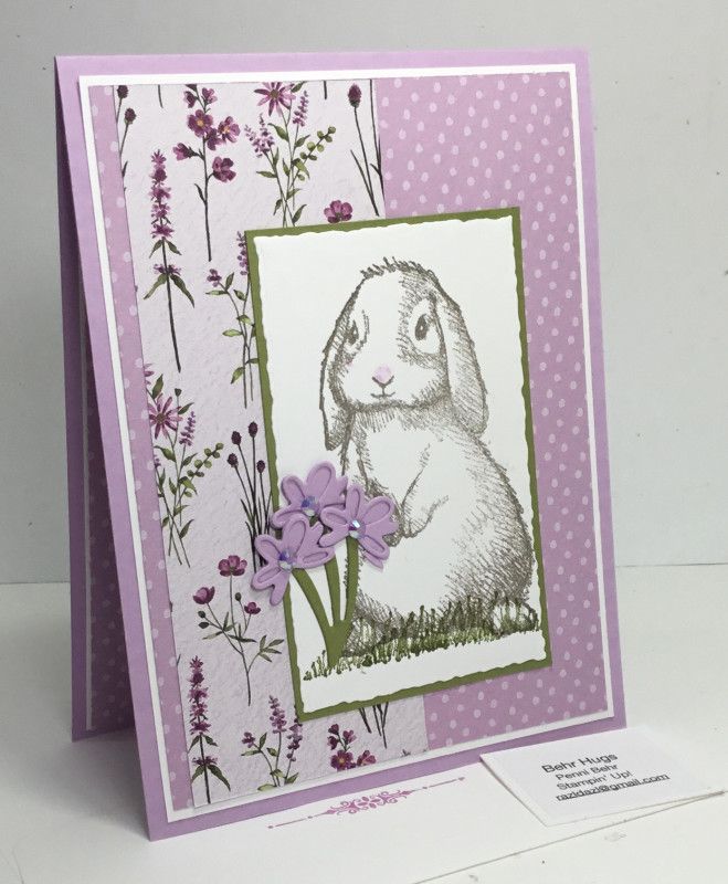 a card with a rabbit and flowers on it