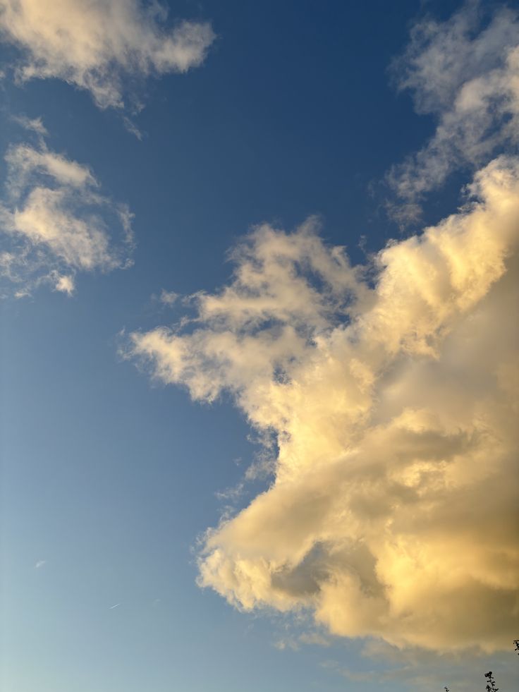 the sky is full of clouds and some trees