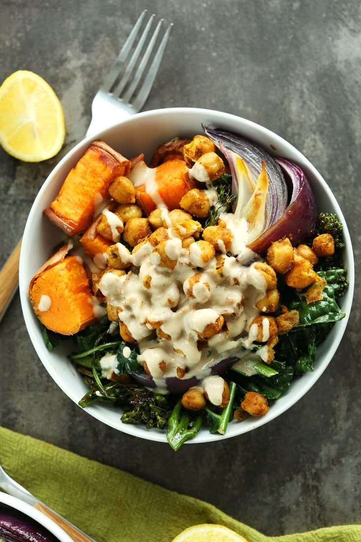 a white bowl filled with vegetables and dressing