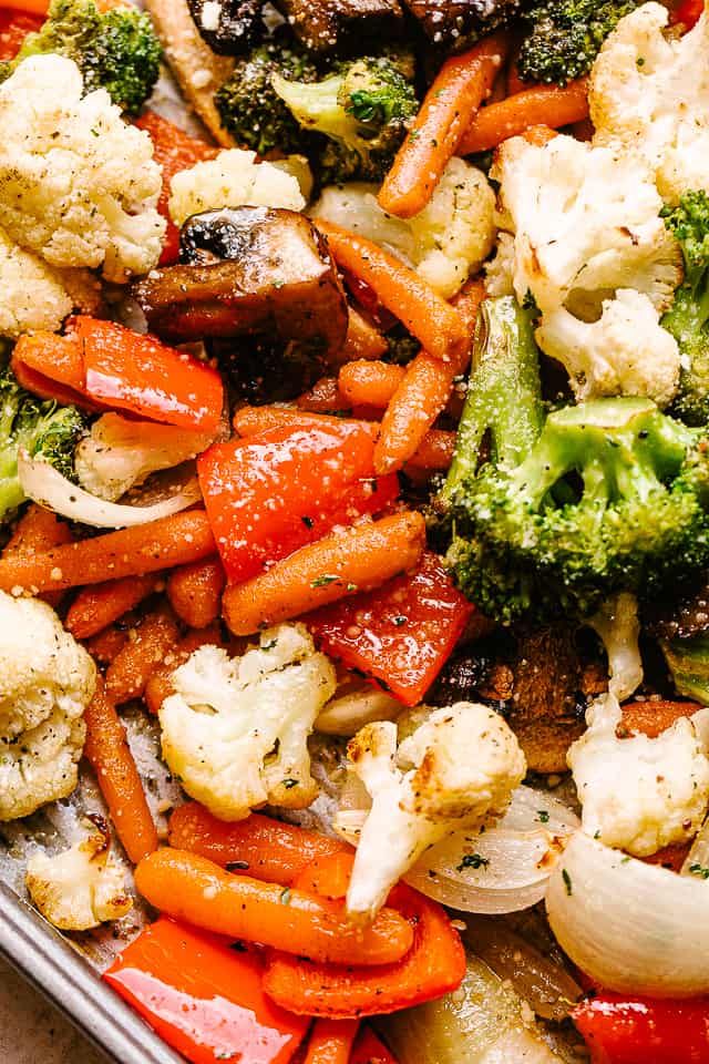 a tray full of vegetables including carrots, cauliflower and broccoli