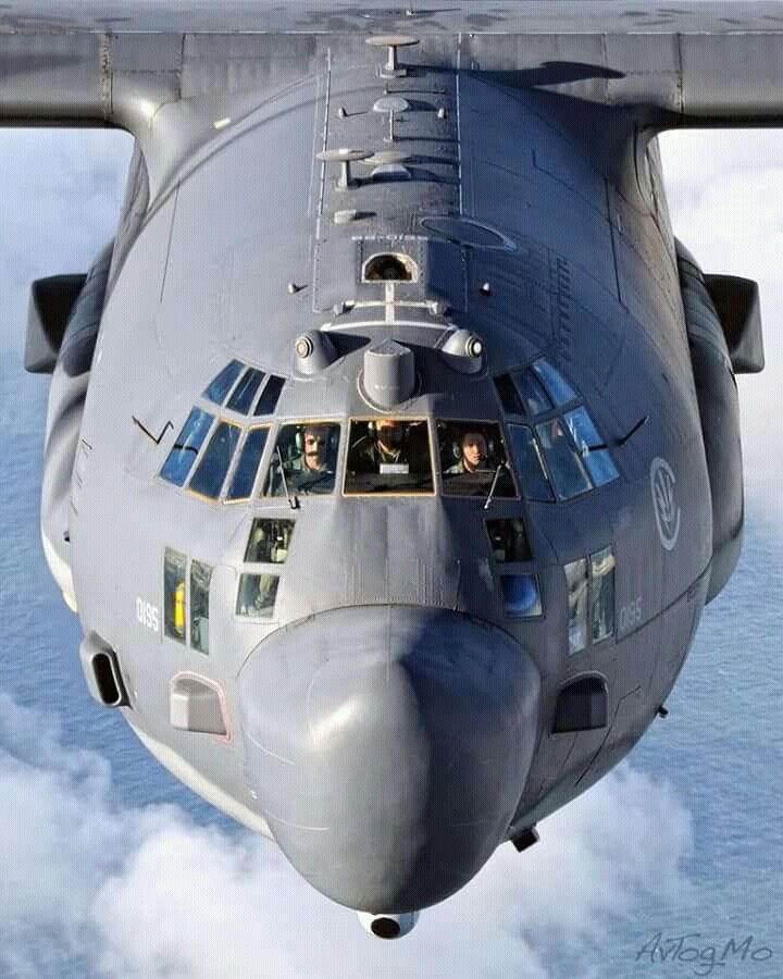 an airplane is flying through the air with people in it's windows and some clouds below