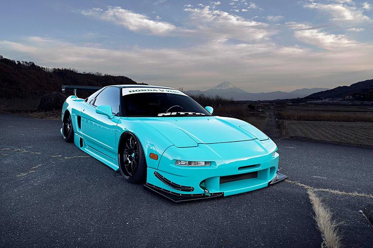 a blue sports car parked in a parking lot