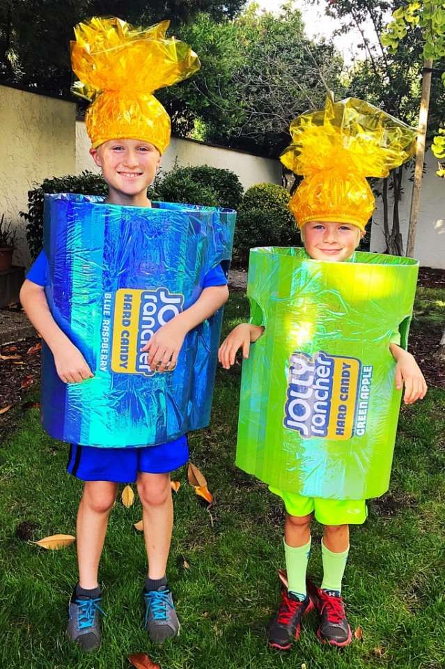 two young boys wearing costumes made out of plastic bags, one with yellow hair and the other blue