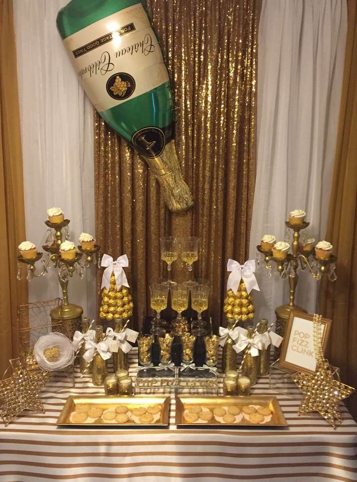 a table topped with champagne bottles and desserts