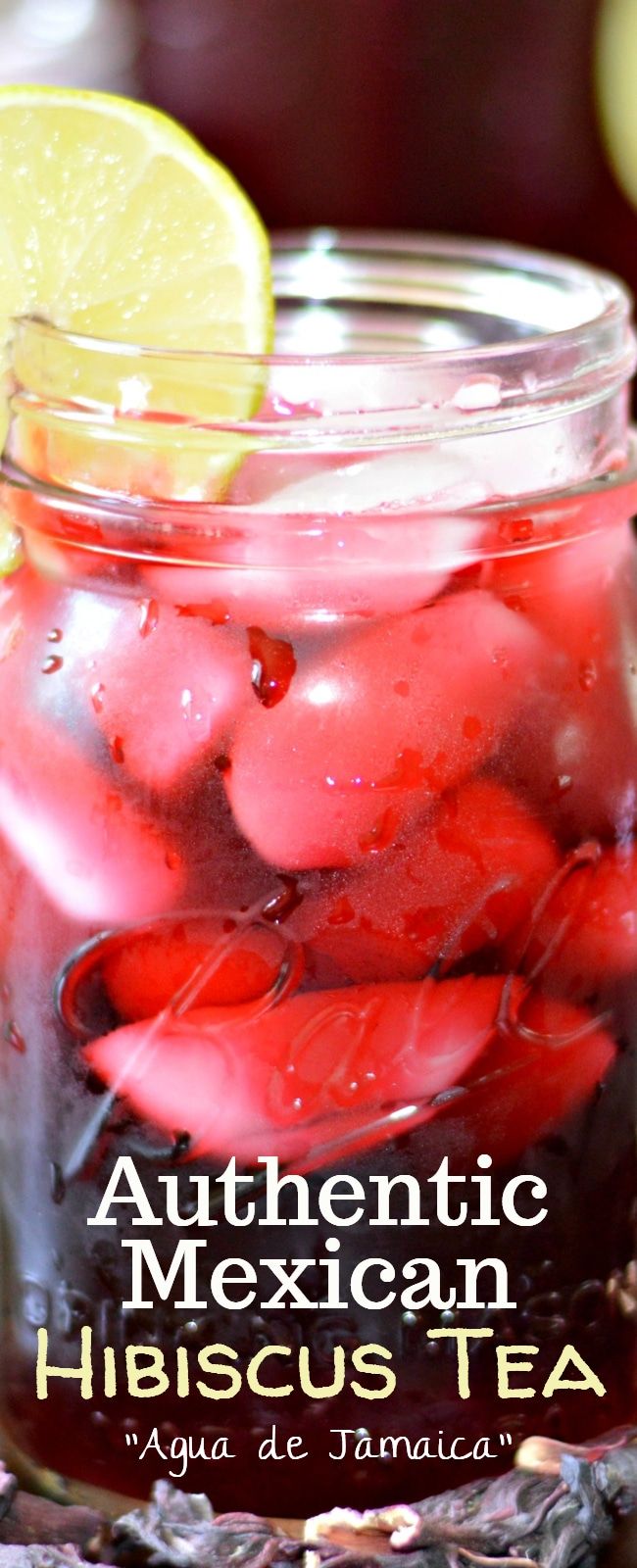 a jar filled with red liquid and lemon wedges