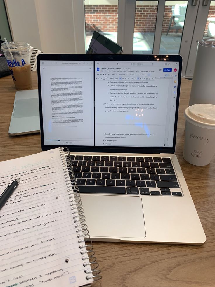 A detail photo of an opened MacBook Air with split tabs on a light brown wood table, next to an opened notebook and a white latte cup Weekly Manifestation, Writer Vibes, Aesthetic Coffee Shop, Study Core, Faceless Content, Coffee Study, Study Vibes, Study Session, Academic Validation