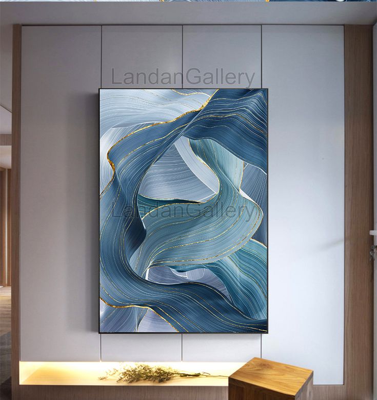 an abstract painting hangs on the wall