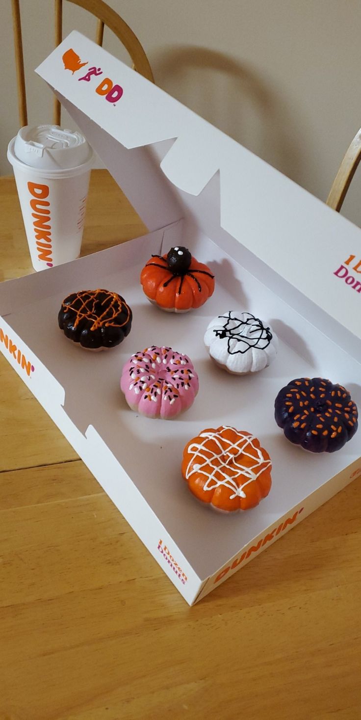 a box filled with donuts sitting on top of a wooden table