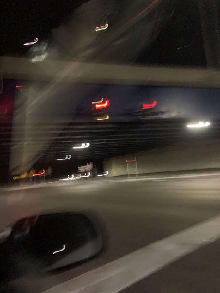 blurry photograph of cars at night on the road