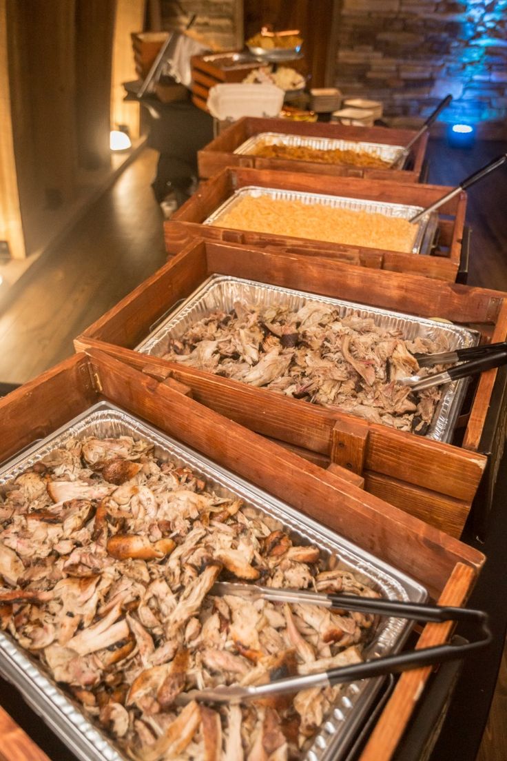 several trays filled with food sitting on top of a table